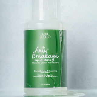 A hair breakage repair treatment bottle of AGUA DE CIELO Anti-Breakage Liquid Mask, featuring a green label with white text, shown on a reflective light gray surface with a clear cap.
