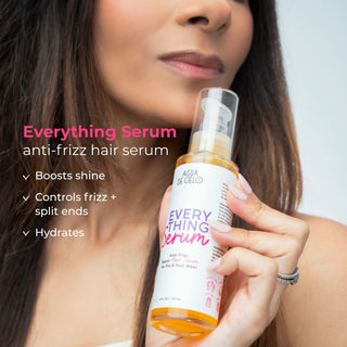 A woman holds a bottle of Agua De Cielo Everything Serum anti-frizz hair serum. The image features promotional text on the left highlighting the benefits of the serum, and the woman is shown holding the product against a clean, light background.