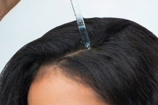 woman using scalp care products by agua de cielo